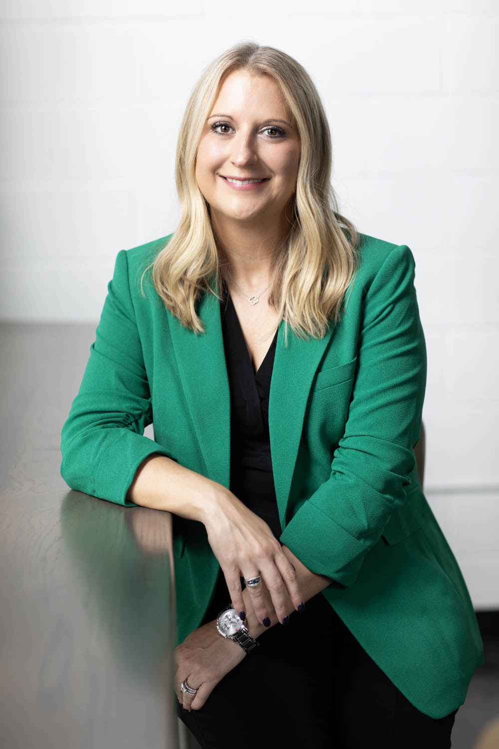 corporate-headshot-female-atlanta-photography Corporate headshot of a female executive sitting at a desk.
