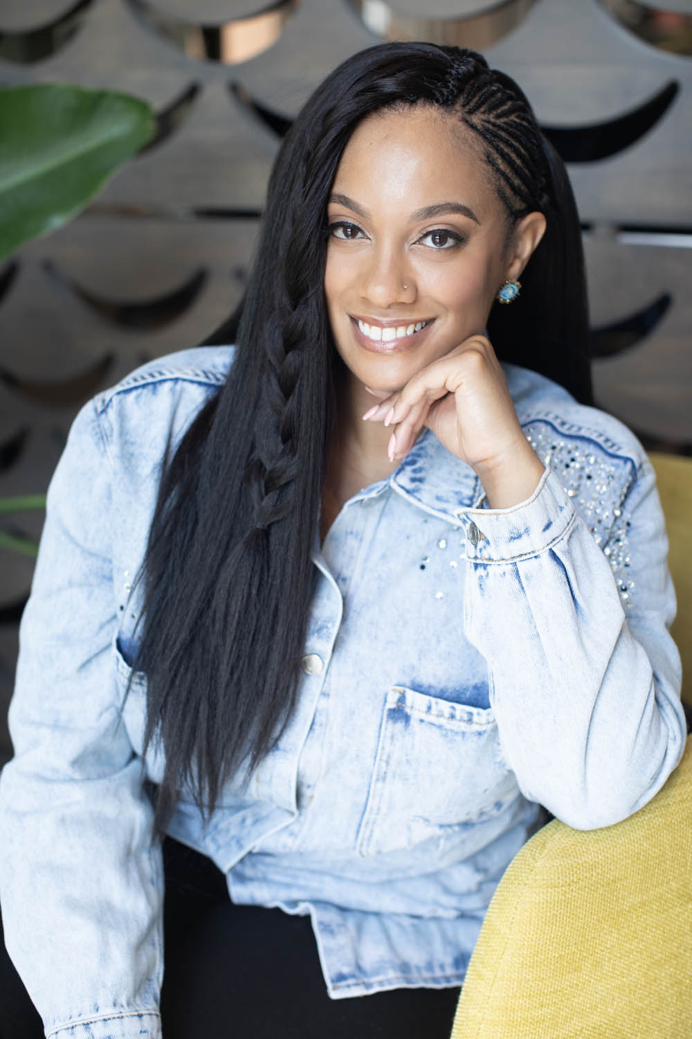 lifestyle-headshot-female-atlanta-photography Lifestyle headshot of a woman on a couch in Midtown Atlanta smiling confidently.